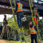Workers install a ceiling to protect the multi-use pathway along the Ottawa River from construction on the Chief William Commanda Bridge. Alayne McGregor/The BUZZ