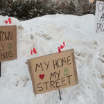 Signs at a community counter-protest to the "Freedom Convoy" on February 5, 2022 (Brett Delmage/The BUZZ)