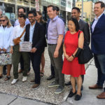 The Downtown Revitalization Task Force at its initial press conference July 29, 2922. Front row (l-r) Christine Leadman of the Bank Street BIA, Councillor Catherine McKenney, MP Yasir Naqvi, Councillor Mathieu Fleury, Centretown Community Association President Mary Huang. Co-chair Graeme Hussey is at the far left. Co-chair Neil Malhotra is second from right at the back. (Alayne McGregor/The BUZZ)