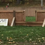 Plouffe Park, with Save-the-park protest signs along the wall of the ice rink. (Alayne McGregor/The BUZZ)