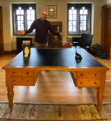The Rev. Jim Pot with his mysterious new/old desk in his office at Knox Presbyterian Church.